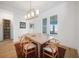 Bright dining room with a wooden table, modern chairs, and natural light from the window at 42239 Lake Timber Dr, Punta Gorda, FL 33982