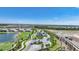 An aerial view of the community's entry showcasing manicured landscaping, palm trees, and a guardhouse, creating a grand entrance at 42239 Lake Timber Dr, Punta Gorda, FL 33982