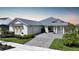 Charming single-story home with a metal roof, well-manicured landscaping, and paved driveway at 42239 Lake Timber Dr, Punta Gorda, FL 33982