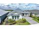 Charming single-Gathering home featuring a light blue exterior and a well-manicured front yard at 42239 Lake Timber Dr, Punta Gorda, FL 33982