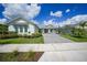 Inviting single-Gathering home with landscaped lawn and a gray brick driveway leading to the attached garage at 42239 Lake Timber Dr, Punta Gorda, FL 33982