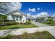 Inviting single-Gathering home with landscaped lawn and a gray brick driveway leading to the attached garage at 42239 Lake Timber Dr, Punta Gorda, FL 33982