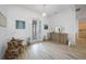Elegant foyer with wood-look tile flooring, decorative furniture, and bright, airy lighting at 42239 Lake Timber Dr, Punta Gorda, FL 33982