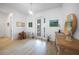 Bright foyer with wood-look tile flooring, elegant decor, and a view to the front porch at 42239 Lake Timber Dr, Punta Gorda, FL 33982