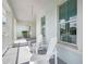 Charming front porch featuring a pair of white Adirondack chairs and views of a well-maintained front yard at 42239 Lake Timber Dr, Punta Gorda, FL 33982