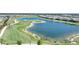 An aerial view of a meticulously maintained golf course and serene lake in this beautiful community at 42239 Lake Timber Dr, Punta Gorda, FL 33982