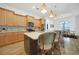 Bright kitchen featuring granite counters, wood cabinets, a center island and stainless appliances at 42239 Lake Timber Dr, Punta Gorda, FL 33982