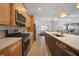 Modern kitchen featuring stainless appliances, granite countertops, and open concept design at 42239 Lake Timber Dr, Punta Gorda, FL 33982