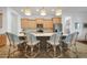 Modern kitchen with light wood cabinets, stainless steel appliances, and a large island with seating at 42239 Lake Timber Dr, Punta Gorda, FL 33982