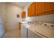 Bright laundry room with washer, dryer, storage cabinets and a sink at 42239 Lake Timber Dr, Punta Gorda, FL 33982