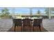 Covered patio featuring serene lake views, an outdoor dining space, and ample room for relaxation at 42239 Lake Timber Dr, Punta Gorda, FL 33982