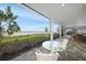 Covered patio featuring serene lake views, an outdoor dining space, and ample room for relaxation at 42239 Lake Timber Dr, Punta Gorda, FL 33982