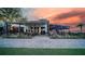Inviting outdoor dining area at sunset, complete with cozy seating and picturesque views at 42239 Lake Timber Dr, Punta Gorda, FL 33982