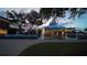 Beautifully lit restaurant exterior at twilight featuring outdoor seating and inviting ambiance at 42239 Lake Timber Dr, Punta Gorda, FL 33982