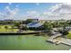 Waterfront restaurant and dock with seating, lush landscaping, and serene water views under a blue sky at 42239 Lake Timber Dr, Punta Gorda, FL 33982