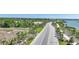 Aerial view of Babcock Ranch entrance with palm-lined road, beautiful lakes and surrounding natural scenery at 42239 Lake Timber Dr, Punta Gorda, FL 33982