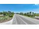 Scenic entrance to Babcock Ranch featuring palm trees and lush landscaping on a sunny day at 42239 Lake Timber Dr, Punta Gorda, FL 33982