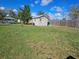 Fenced backyard with a small shed, lawn and a clear view of the bright blue sky at 447 Yeager St, Port Charlotte, FL 33954
