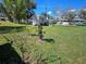 Large backyard with small shed, well-maintained lawn, and sunny sky at 447 Yeager St, Port Charlotte, FL 33954