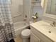 Well-lit bathroom features a shower-tub combo with safety grab bars and a ceramic sink vanity at 447 Yeager St, Port Charlotte, FL 33954