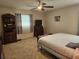 Spacious bedroom featuring carpet flooring, a window, and a ceiling fan at 447 Yeager St, Port Charlotte, FL 33954
