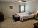 Calm bedroom with a queen-sized bed, carpet flooring, and a large window at 447 Yeager St, Port Charlotte, FL 33954
