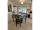 Bright dining area features tile floors, a table with four chairs, and access to the patio at 447 Yeager St, Port Charlotte, FL 33954