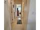 Hallway with tile floors showing access to other rooms of the home with neutral paint at 447 Yeager St, Port Charlotte, FL 33954