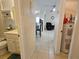 Hallway with tile floors showing access to the bathroom, dining, and living areas of the home at 447 Yeager St, Port Charlotte, FL 33954