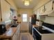 Functional kitchen with white cabinets, updated appliances, and wood countertops at 447 Yeager St, Port Charlotte, FL 33954