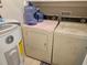 Bright laundry area with washer, dryer, and water heater at 447 Yeager St, Port Charlotte, FL 33954