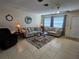 Comfortable living room with neutral-toned furniture, a ceiling fan, and natural light at 447 Yeager St, Port Charlotte, FL 33954