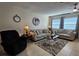 Comfortable living room with tile floors, neutral paint, ceiling fan, and lots of seating options at 447 Yeager St, Port Charlotte, FL 33954