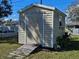 A small shed with a ramp and neutral door and window trim at 447 Yeager St, Port Charlotte, FL 33954