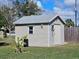 Side view of a well-maintained shed in a fenced yard with a metal roof at 447 Yeager St, Port Charlotte, FL 33954