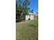 Backyard shed with a window, light fixture, and a clear view of the sunny sky at 447 Yeager St, Port Charlotte, FL 33954