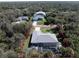 Aerial view of the home highlighting its location near mature landscaping and an enclosed pool at 4529 Enid Ln, North Port, FL 34288