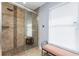 Comfortable bathroom featuring a glass enclosed shower with stone floors and a bright window at 4529 Enid Ln, North Port, FL 34288