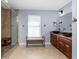 Bathroom with dual sinks, granite countertop, walk-in shower with glass door and a relaxing bench at 4529 Enid Ln, North Port, FL 34288