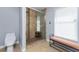 Comfortable bathroom featuring a glass enclosed shower with stone floor, bench seat, toilet, and a bright window at 4529 Enid Ln, North Port, FL 34288