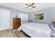 Bedroom with wood-look floors, natural light, a ceiling fan, neutral walls, closet and a queen bed at 4529 Enid Ln, North Port, FL 34288