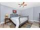 Bedroom featuring a queen bed, neutral walls, wood-look floors, ceiling fan and bright natural light at 4529 Enid Ln, North Port, FL 34288