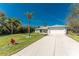 Well-maintained single Gathering home featuring a manicured lawn and a long driveway at 4529 Enid Ln, North Port, FL 34288
