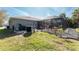 Home exterior with a screened-in pool and patio area, surrounded by well-maintained landscaping at 4529 Enid Ln, North Port, FL 34288