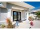 Inviting front porch with double glass doors and stylish columns providing curb appeal at 4529 Enid Ln, North Port, FL 34288