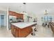 Bright kitchen boasts stainless steel appliances, custom cabinets, large island, and sleek countertops at 4529 Enid Ln, North Port, FL 34288