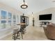 The living room is spacious and bright with tiled floors, a ceiling fan, recessed lighting, and plantation shutters at 4529 Enid Ln, North Port, FL 34288