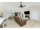 Open-concept living room features neutral walls, ceiling fan, tile floors, and natural light at 4529 Enid Ln, North Port, FL 34288