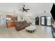 The living room features tiled flooring, recessed lights, a sofa, a coffee table, and flows into the dining area at 4529 Enid Ln, North Port, FL 34288