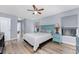 Bright main bedroom boasts ceiling fan, hardwood floors, and soothing color scheme at 4529 Enid Ln, North Port, FL 34288